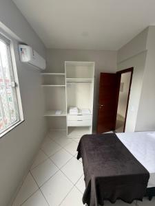 a white room with a bed and a closet at Apartamento COP 30, Belém in Belém