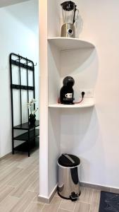 a phone sitting on a shelf in a room at LE COCOON - Proche Centre - Climatisation - Wifi in Menton