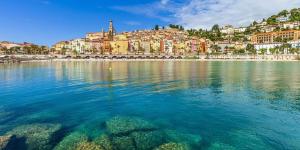a large body of water with a city in the background at LE COCOON - Proche Centre - Climatisation - Wifi in Menton