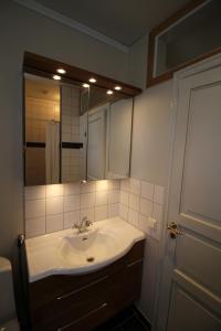 a bathroom with a sink and a mirror at Gästlägenhet in Sövde +7 photos