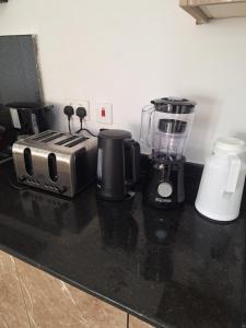 a kitchen counter with a blender and a toaster at Almasi Suites at Sandyshore Beach Resort in Kikambala