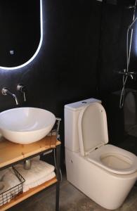 a bathroom with a white toilet and a sink at Mindori glamping in Kvemo-Chocheti +12 photos