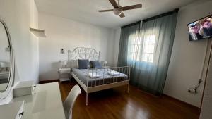 a bedroom with a crib in front of a window at Amanecer zen in Argés