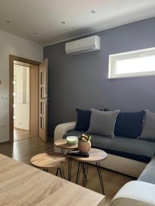 a living room with a couch and a table at Apartman Nora in Široki Brijeg