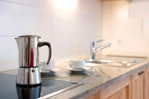a coffee maker sitting on a counter in a kitchen at Kaltenhauser Hof in Masserie +85 photos