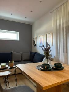 a living room with a table and a couch at Apartman Nora in Široki Brijeg +9 photos