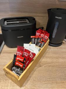 a box of chips next to a toaster at Apartman Nora in Široki Brijeg