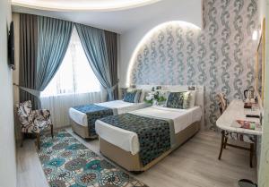 Postel nebo postele na pokoji v ubytování Dündar Hotel