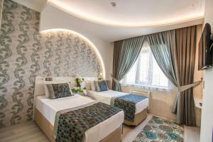Postel nebo postele na pokoji v ubytování Dündar Hotel