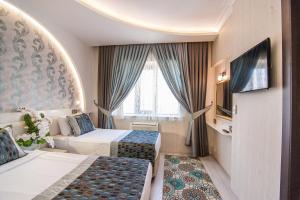 Postel nebo postele na pokoji v ubytování Dündar Hotel