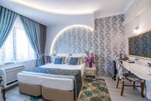 Postel nebo postele na pokoji v ubytování Dündar Hotel