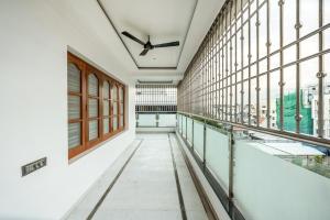 a corridor of a building with windows and a ceiling at HSR Penthouse Spacious 4-BHK Apartment with Living, Lounge Area, Study Room, Terrace & Balconies in Bengaluru