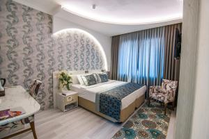 Postel nebo postele na pokoji v ubytování Dündar Hotel