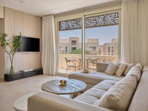 a living room with a couch and a table at Boutique Residence Mangroovy-Lemon Spaces Gouna in Hurghada