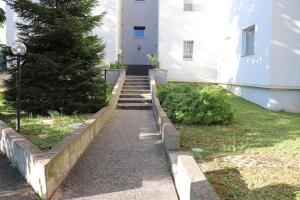 a set of stairs leading to a white building at Casa Rovedine in Opera