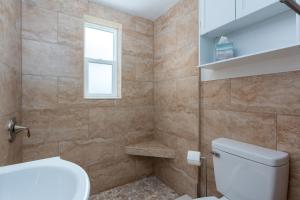 a bathroom with a toilet and a window at Tropic Terrace Suite #4 - Beachfront Resort in St Pete Beach +28 photos