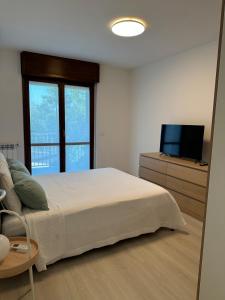 a bedroom with a large bed and a television at Casa Rovedine in Opera