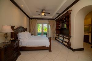 a bedroom with a bed and a dresser and a television at Bella Vista 3F 3 bdr beach club view in Los Suenos in Herradura +44 photos