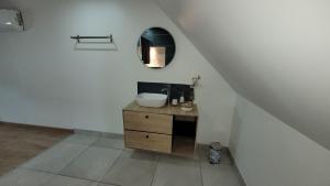 a bathroom with a sink and a mirror on the wall at " Bulles et Evasion - Maison, Spa en option" in Ville-le-Marclet