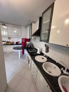 a kitchen with two sinks and a counter top at Villa Pina b&b in Colleferro
