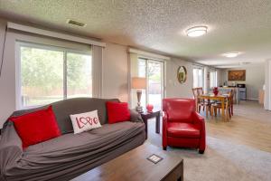 a living room with a couch and a red chair at Heart of Denver Suburbs! Extended-Stay Duplex in Littleton