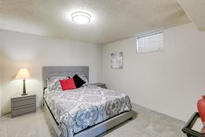 a bedroom with a bed and a lamp at Heart of Denver Suburbs! Extended-Stay Duplex in Littleton