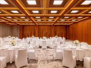 a conference room with white tables and chairs and white tablesearcher at Raffles Europejski Warsaw in Warsaw