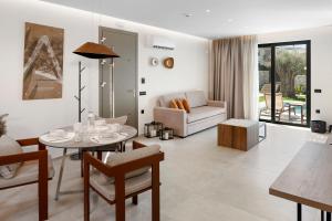a living room with a table and a couch at Luxury Suites with private pool and BBQ by Kalles Homes & Suites in Áno Kalésia