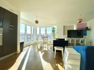 a living room with a couch and a living room with a table at Maidenehad Spacious Spectacular and Modern 3 Bedroom 2 Bathroom Penthouse 14 in Maidenhead