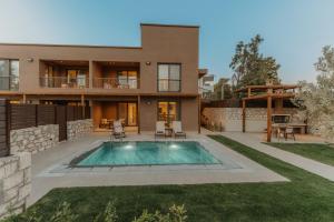 a house with a swimming pool in the yard at Luxury Suites with private pool and BBQ by Kalles Homes & Suites in Áno Kalésia