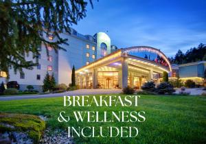 a building with the words breakfast and wellness included at Wellness & Spa Hotel Kaskady in Sliač