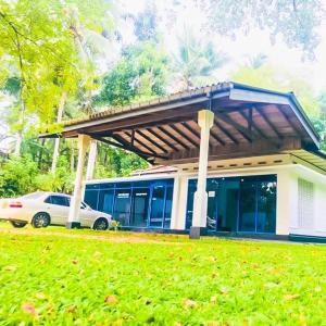 a car parked in front of a house at Hotel Rays Lanka Avissawella in Avissawella