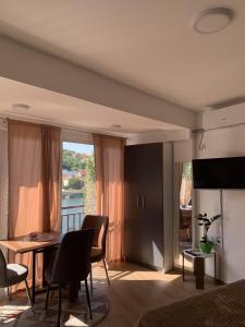 a living room with a table and chairs and a window at Apartment Aluna 4 in Višegrad