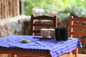 a table with a blue table cloth and cups on it at LÝ GIA HOMESTAY in Ha Giang +73 photos