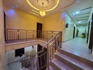 a staircase in a building with a chandelier at Prym Hotel in Owerri