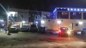 a group of cars parked in a parking lot at night at Prym Hotel in Owerri
