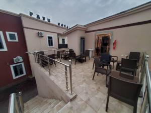a patio with chairs and tables in a building at Prym Hotel in Owerri