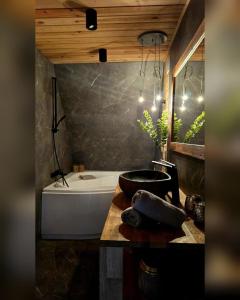 a bathroom with a bath tub and a sink at Chill House Wierzchucinek in Wierzchucinek +24 photos