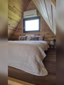 a bedroom with a large bed with a window at Chill House Wierzchucinek in Wierzchucinek