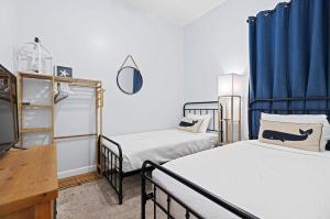 two beds in a room with blue drapes at Happy Days - Seagrove Highlands in Santa Rosa Beach +35 photos