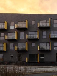 a building with balconies on the side of it at Unwind in Style - 2 BR - Hiking - Family in Tórshavn