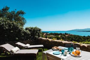 a picnic table with a view of the water at Le Ville Le Saline in Palau