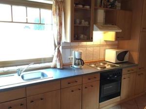 a kitchen with a sink and a microwave at Alex HA03 in Sögel