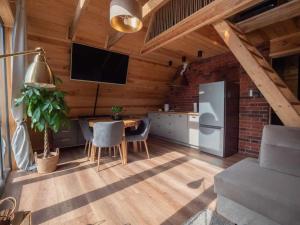 a kitchen with a table and a refrigerator at Chill House Wierzchucinek in Wierzchucinek