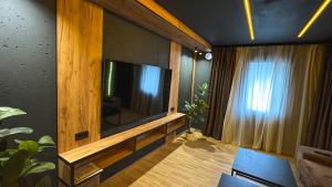 a living room with a large flat screen tv at Hostel Olevsk in Olevsk +34 photos