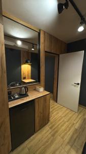 a kitchen with a white door in a room at Hostel Olevsk in Olevsk