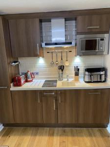 a kitchen with a sink and a microwave at Fell View in Troutbeck