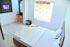 Postel nebo postele na pokoji v ubytování Hotel Srees