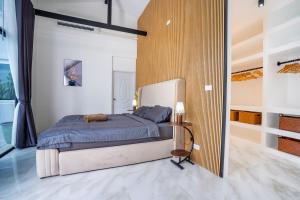 a bedroom with a king sized bed in a room at Bangkok Luxury Private Pool & Jacuzzi Villa , Daily Maid in Bang Bua Thong +43 photos
