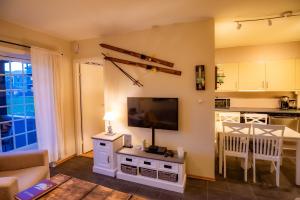 a living room with a flat screen tv on a wall at Høyfjellsgrend 961, 36b in Trysil